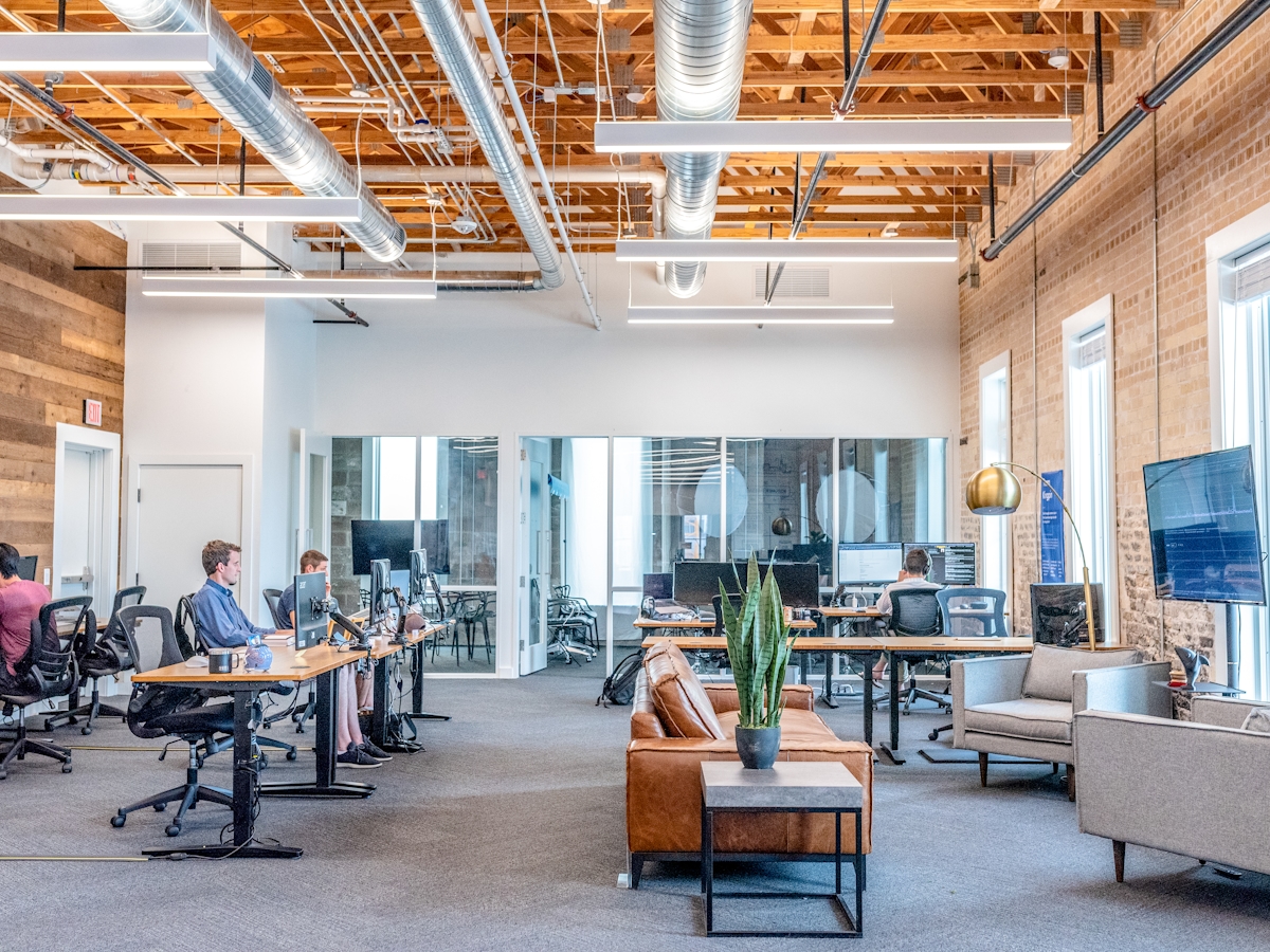 office workstation with monitors displaying smart building control interface for DALI-2 lighting automation