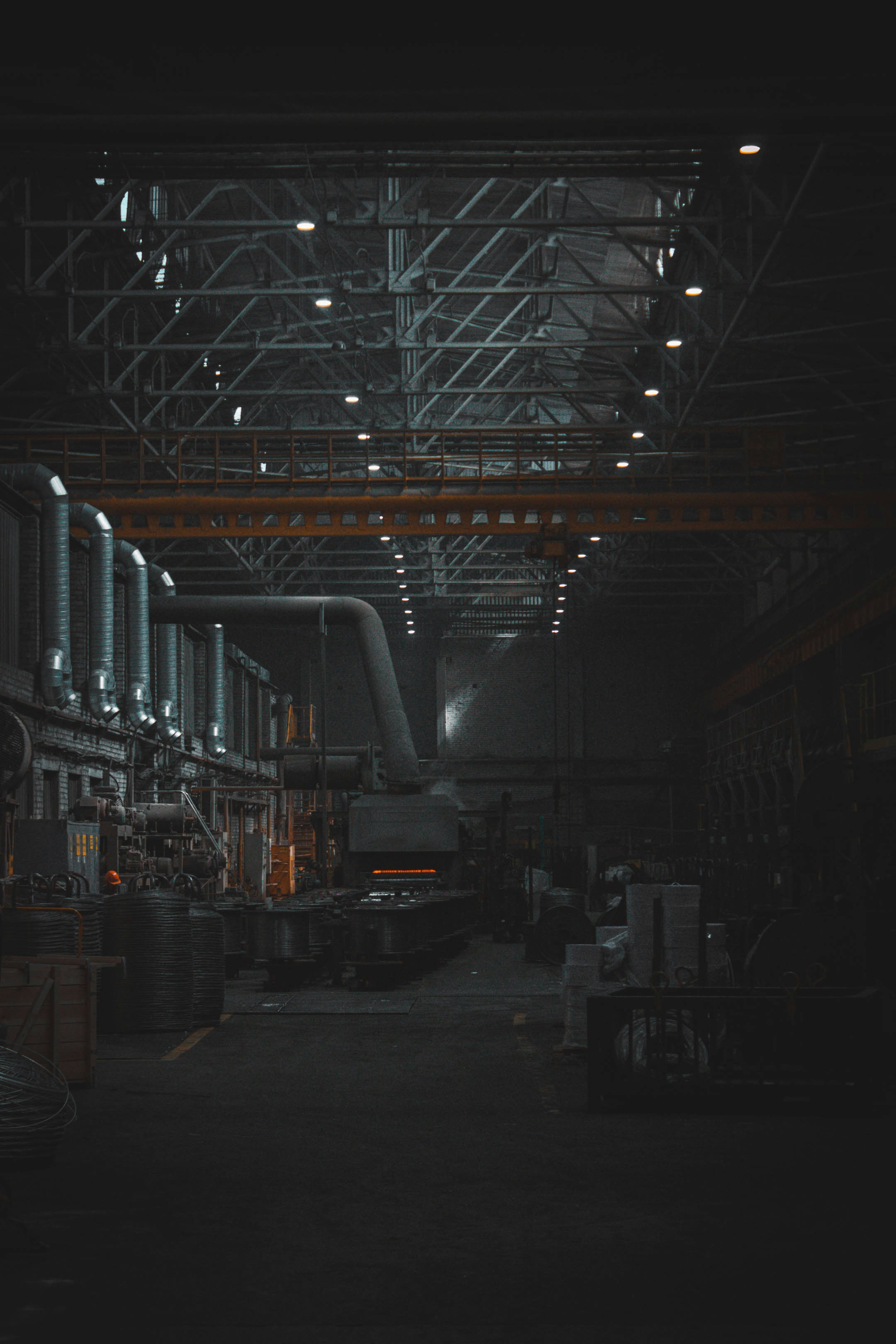 warehouse interior with rows of industrial high-bay LED lights illuminating storage aisles