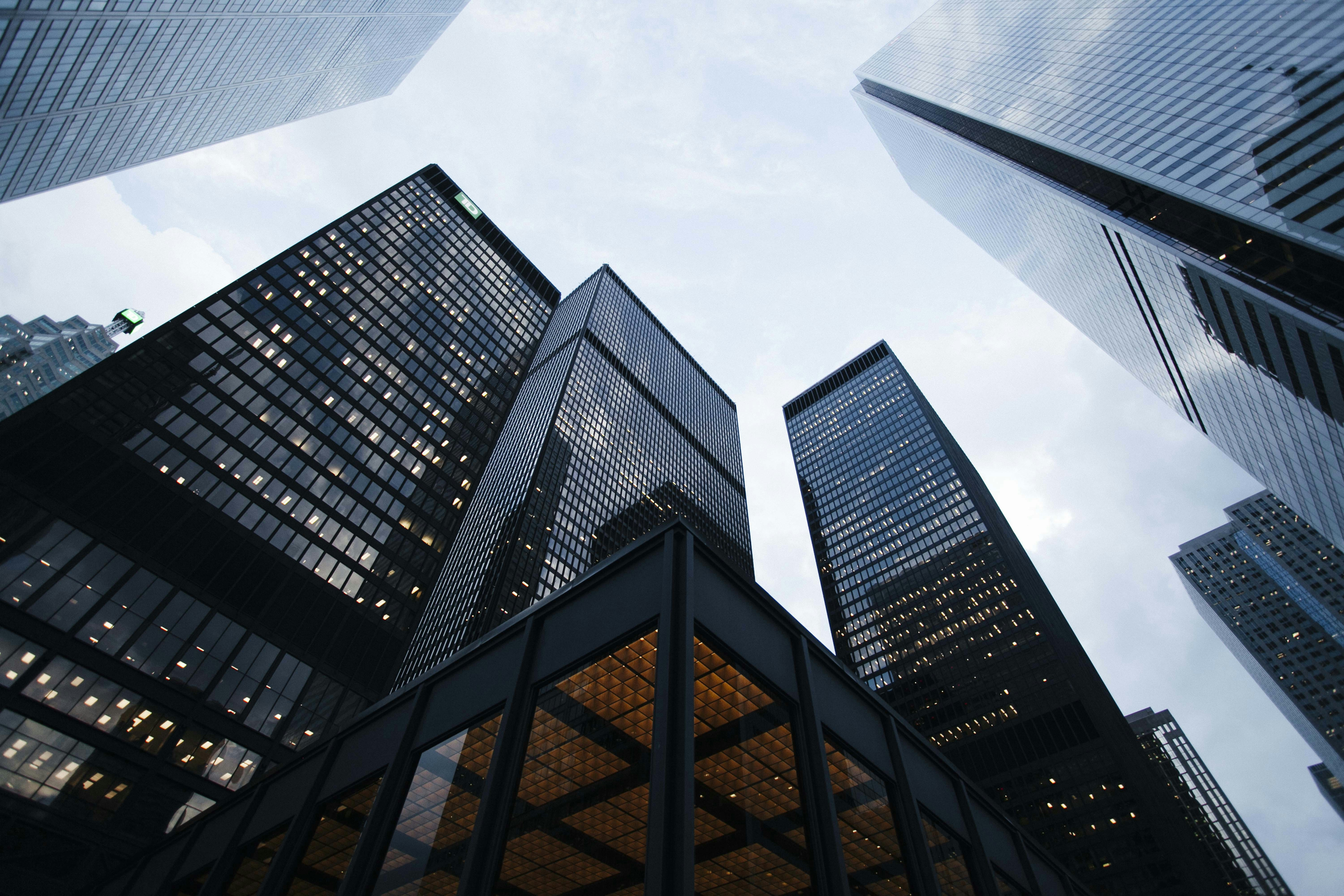 modern commercial office building exterior with energy-efficient LED lighting illuminating glass facade at dusk
