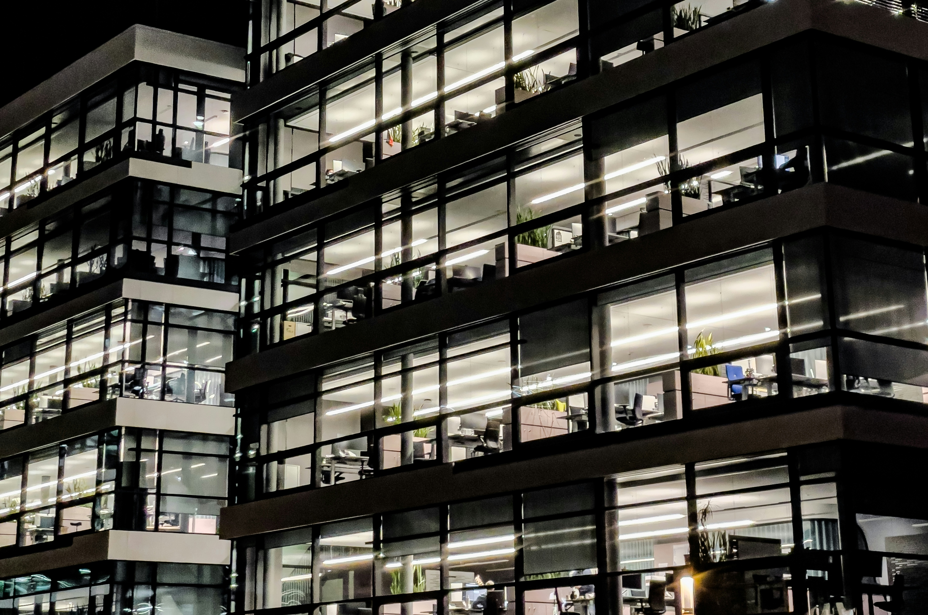 modern office building illuminated at night with smart LED lighting systems