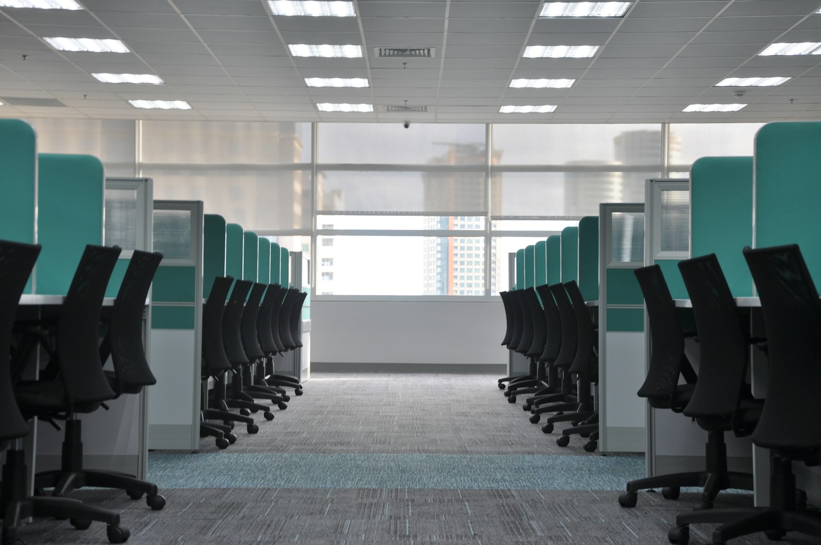 office cubicle workspace with overhead LED panel lighting meeting California Title 24 LPD requirements