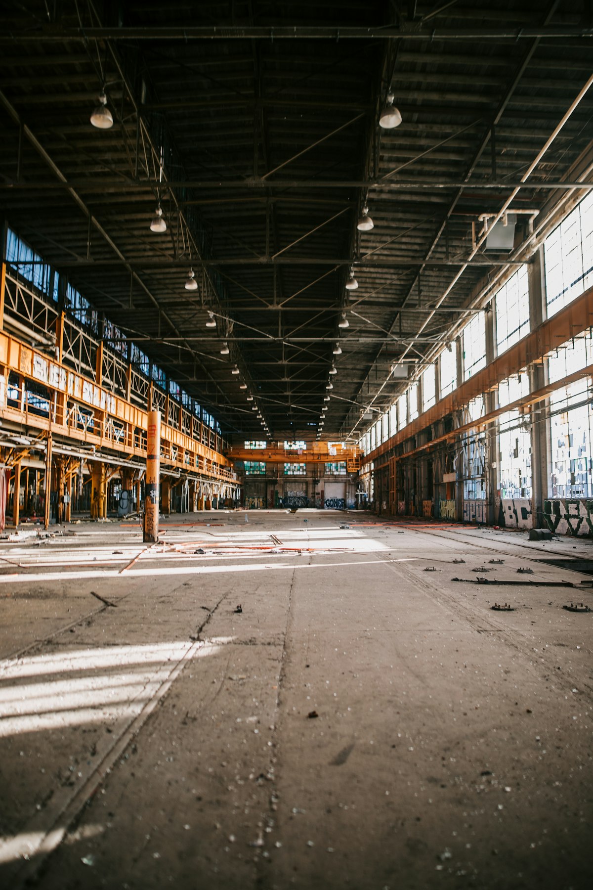 warehouse with large windows allowing natural daylight to complement LED lighting fixtures